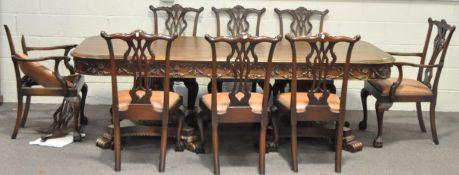 A large carved mahogany pedestal dining table, six dining chairs and two armchairs,