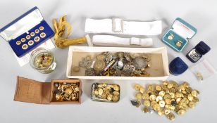 A box of military items, including a collection of naval Gaunt brass buttons,