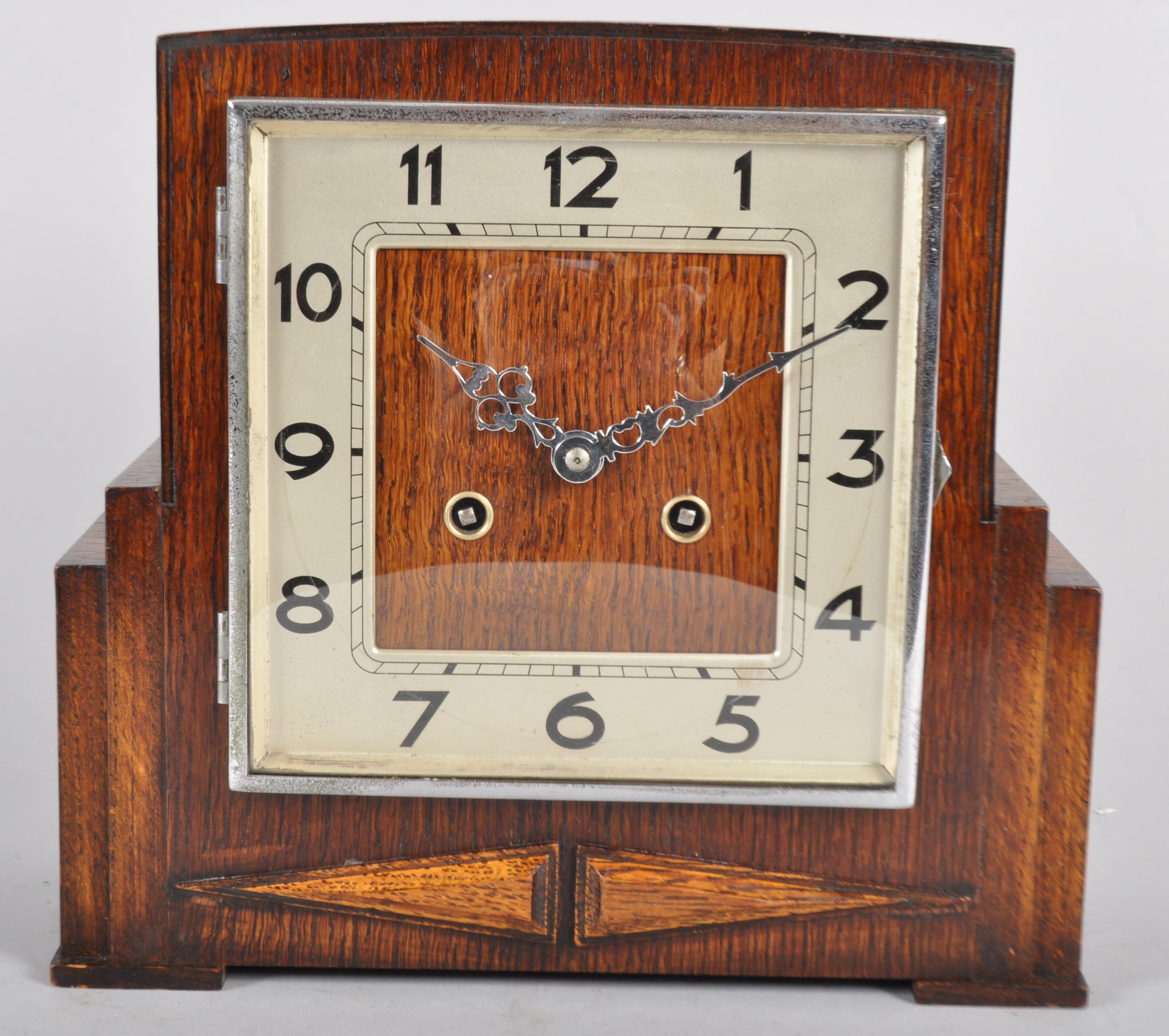 An oak cased Art Deco clock, of rectangular stepped form, striking on a gong,