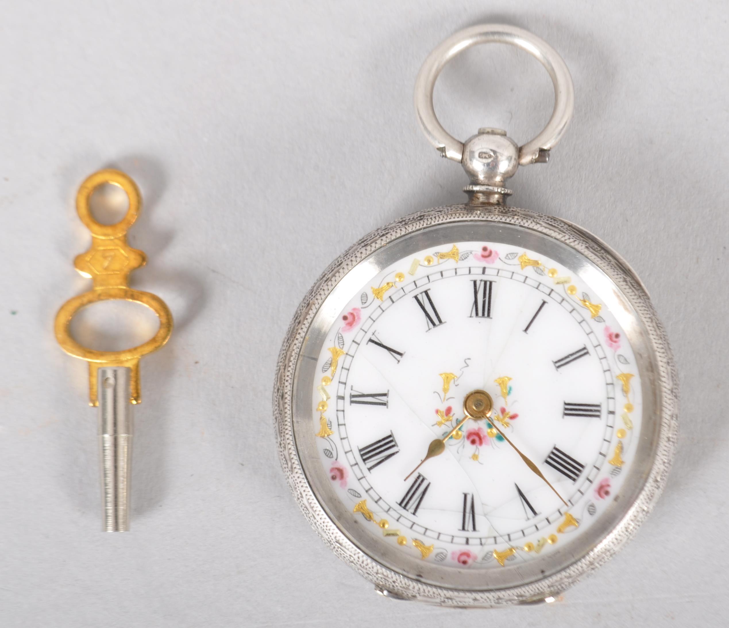 A silver 0.935 key would open face pocket watch. White ceramic dial with floral embellishments.