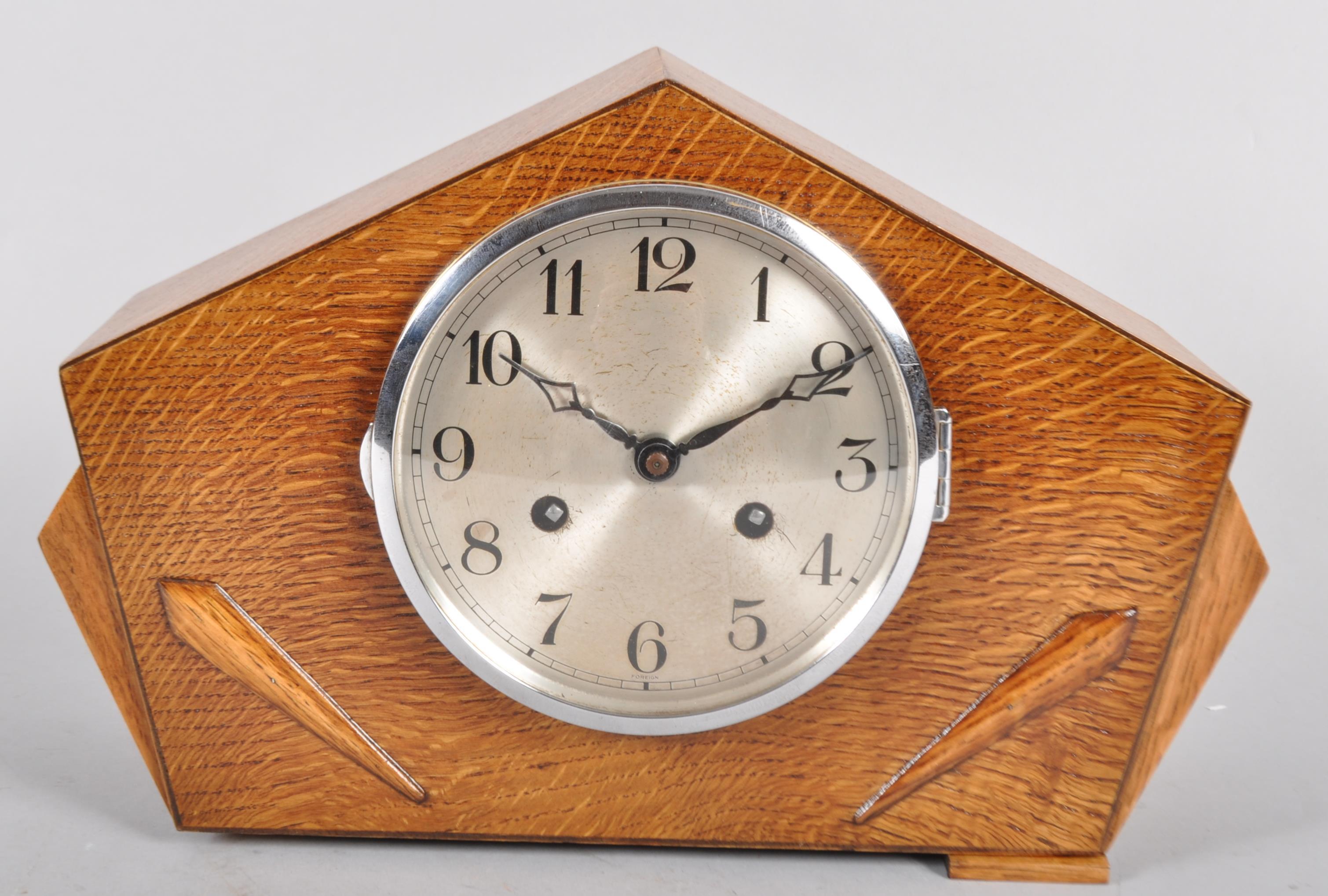 A German (Franz Hermle & Sohn) light oak Art Deco clock with circular silvered dial,