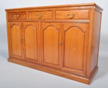 A 20th century Chinese rosewood sideboard, having a three drawer over cupboards configuration,