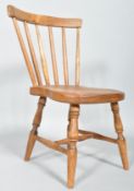 An elm child's stick back kitchen chair, with curved top rail and spindle back,