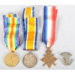 Three World War I medals and a cap badge, comprising : The Victory medal,