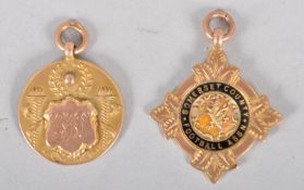A group of two 9ct gold football prize fobs of round and starred form