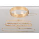 A collection of jewellery to include: A rolled gold half engraved bangle;