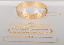 A collection of jewellery to include: A rolled gold half engraved bangle;
