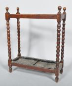 A 19th century Victorian oak bobbin turned double stick stand with finial tops,