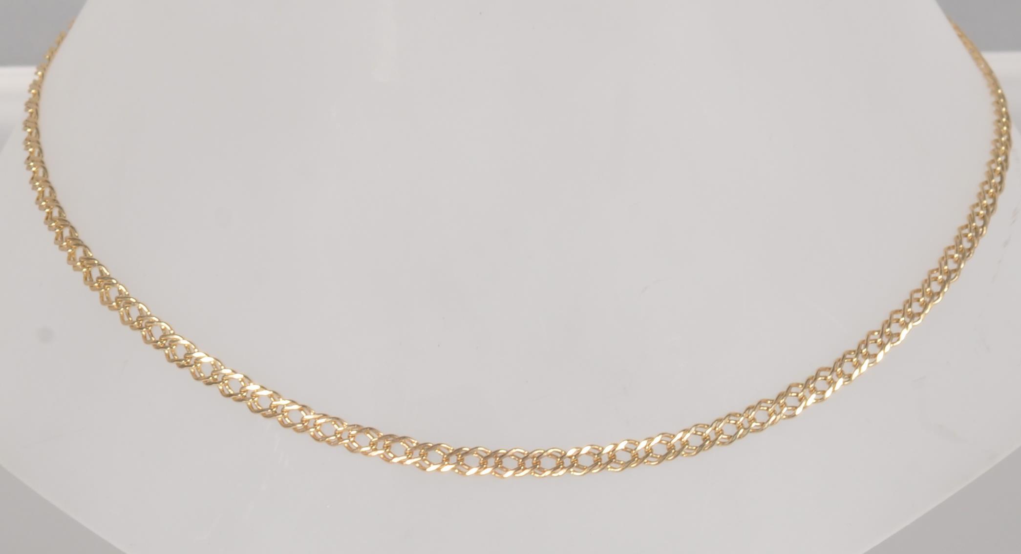 A yellow metal double curb link chain18 inch length, bolt ring clasp.
