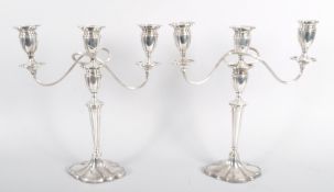 A pair of silver plated neo-classical three light candelabra,