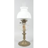 A Victorian brass mounted oil lamp, with opaline shade above clear glass well,