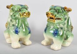 A pair of pottery Chinese style Dogs of Fo, each modelled standing foresque,