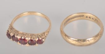 A collection of two rings to include: A 9ct gold half hoop garnet ring;