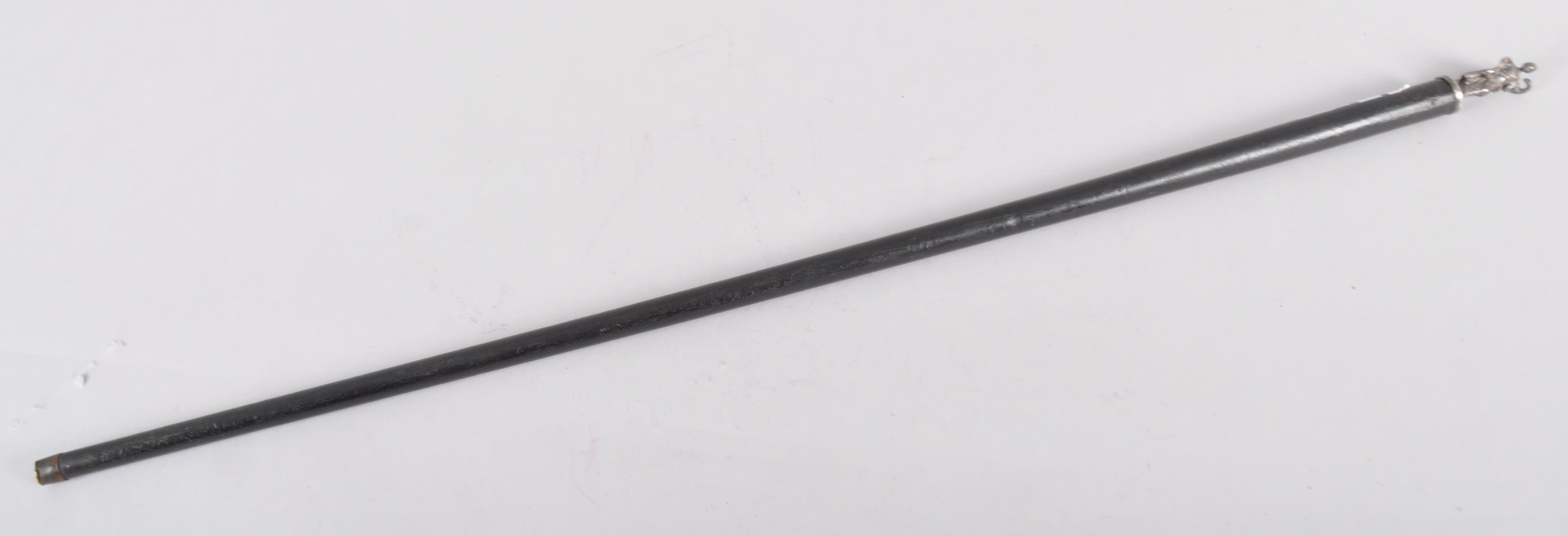 An ebonised walking cane with white metal applied figure of a classical lady,