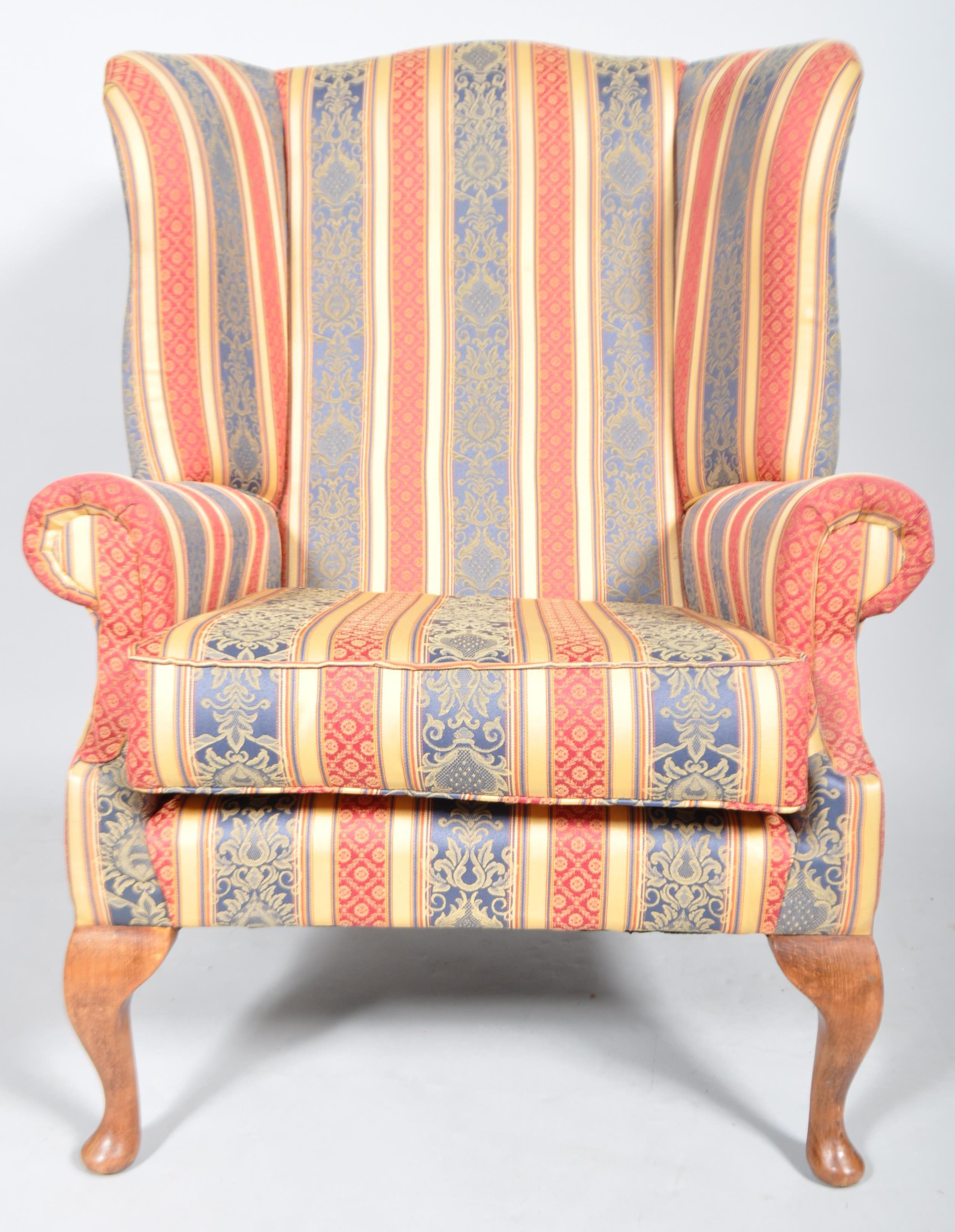 A 20th century Queen Anne style upholstered wing back armchair with barrel rolled arms, - Image 2 of 3