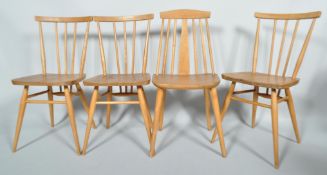 Three Ercol pale elm and beech stick back dining chairs, and another similar,