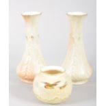 A Royal Worcester globular blush ivory ground vase, painted with robins in flight,17cm high,