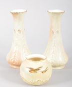 A Royal Worcester globular blush ivory ground vase, painted with robins in flight,17cm high,