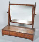 A late George III mahogany swing toilet mirror,