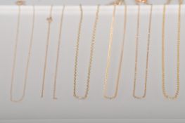 A collection of six yellow metal linked necklace chains.