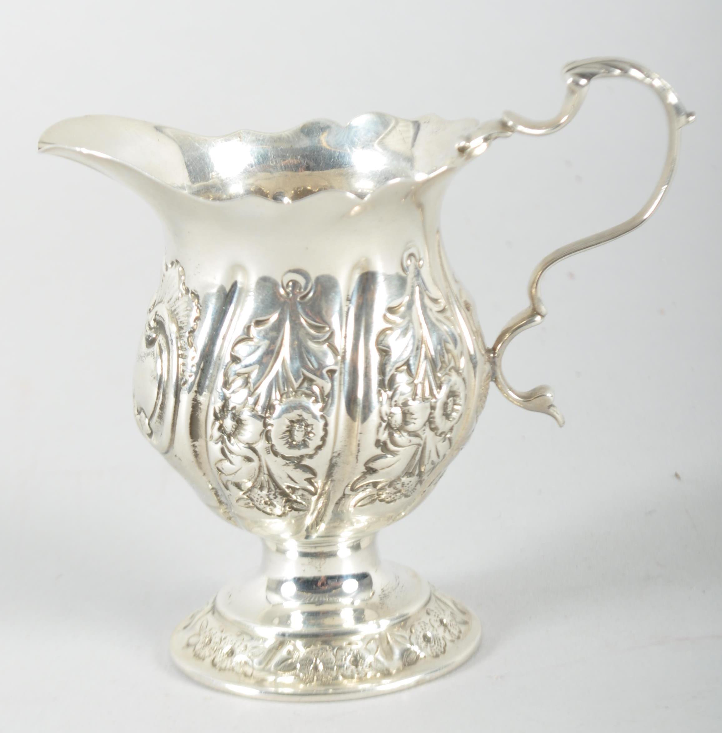 A small silver cream jug, in the 18th century style,