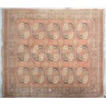 A pale pink ground wool carpet with three rows of five black,