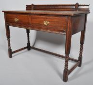 An Edwardian Harris Lebus oak side table, fitted with two drawers, on turned supports,