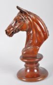 A carved hardwood bust of a horse in the form of a outsized chess piece knight
