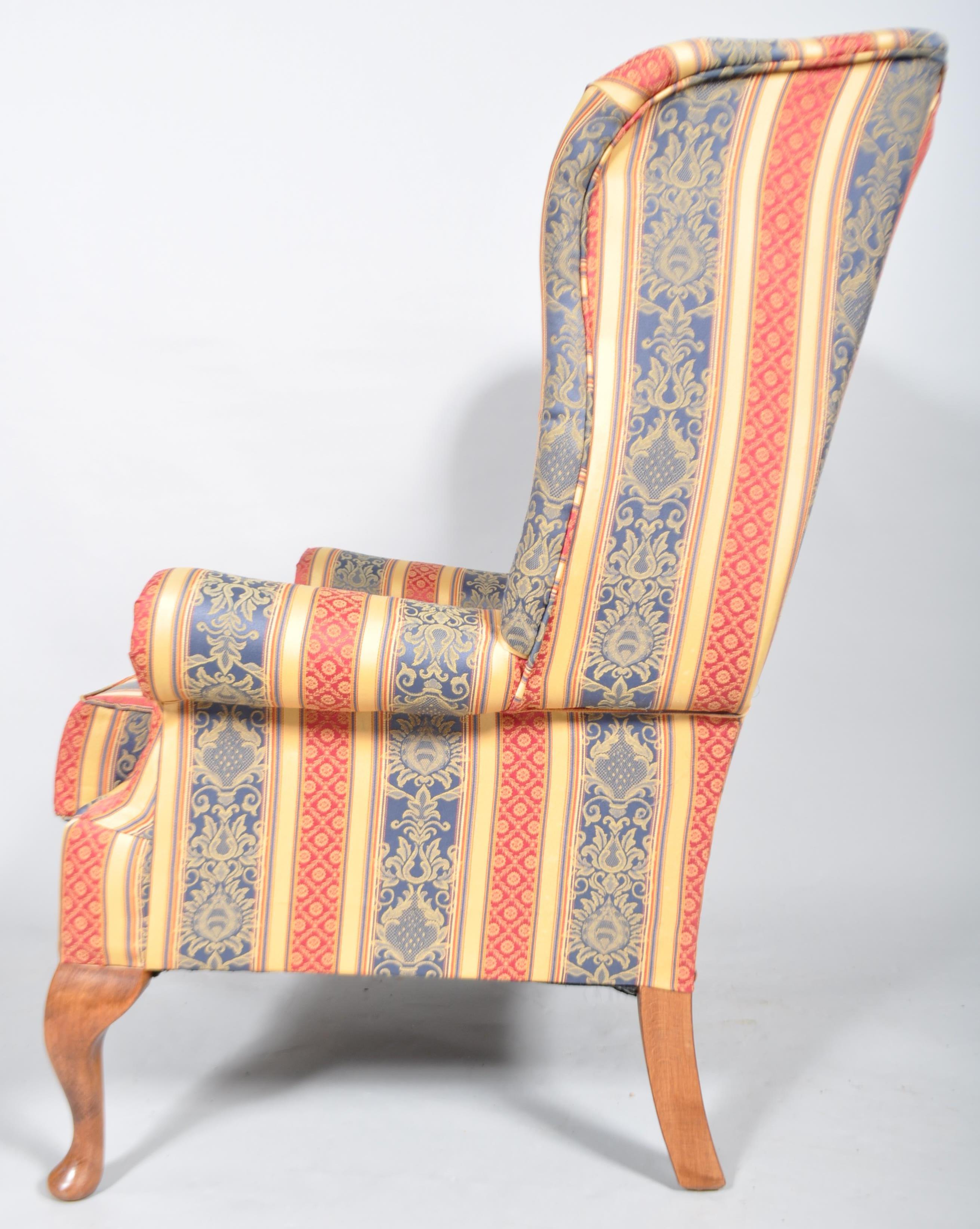 A 20th century Queen Anne style upholstered wing back armchair with barrel rolled arms, - Image 3 of 3