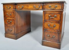 A mahogany twin-pedestal desk in the George III style,