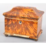 A George III tortoiseshell and ivory tea caddy, of hinged casket form,