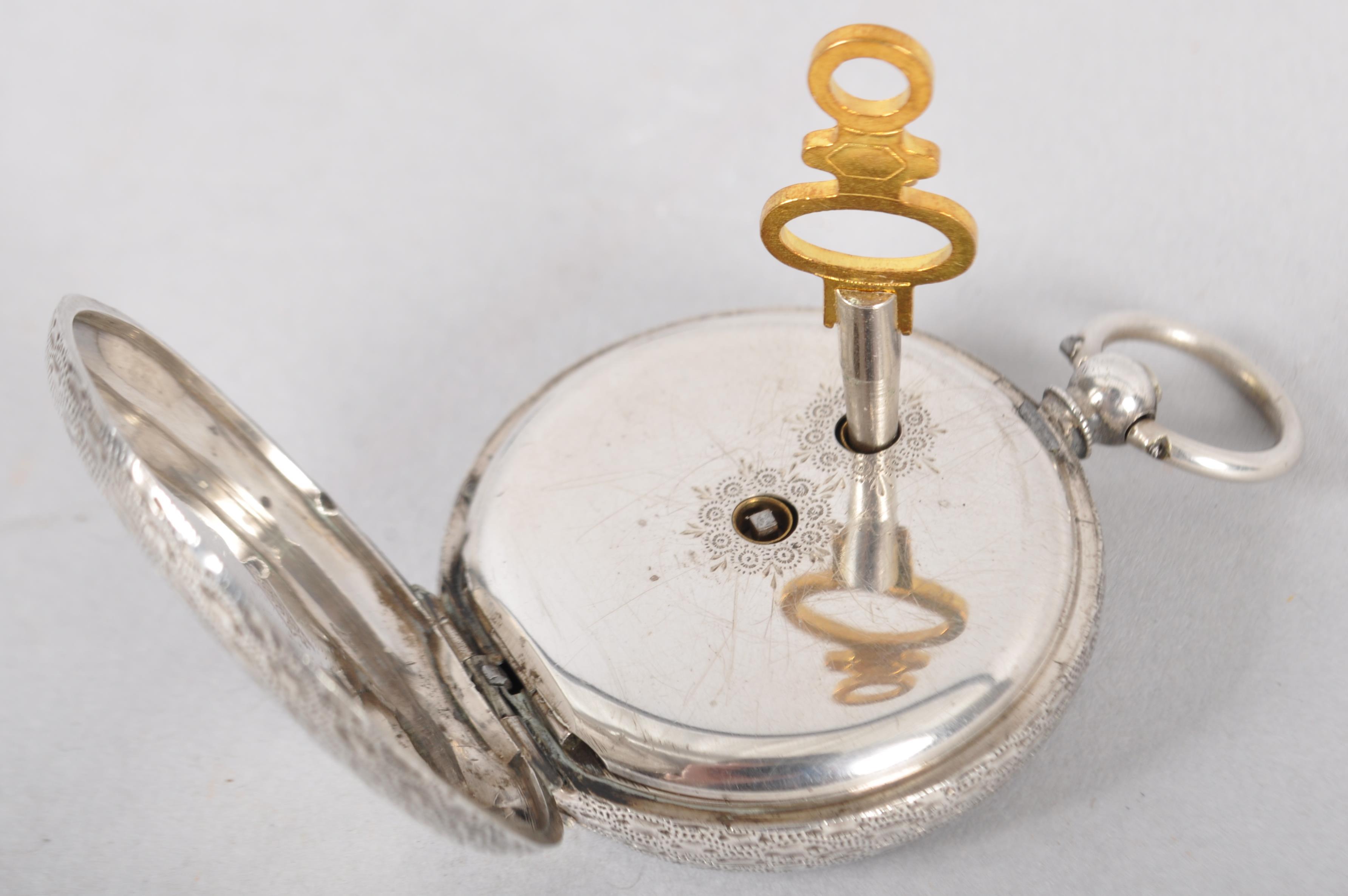 A silver 0.935 key would open face pocket watch. White ceramic dial with floral embellishments. - Image 2 of 2