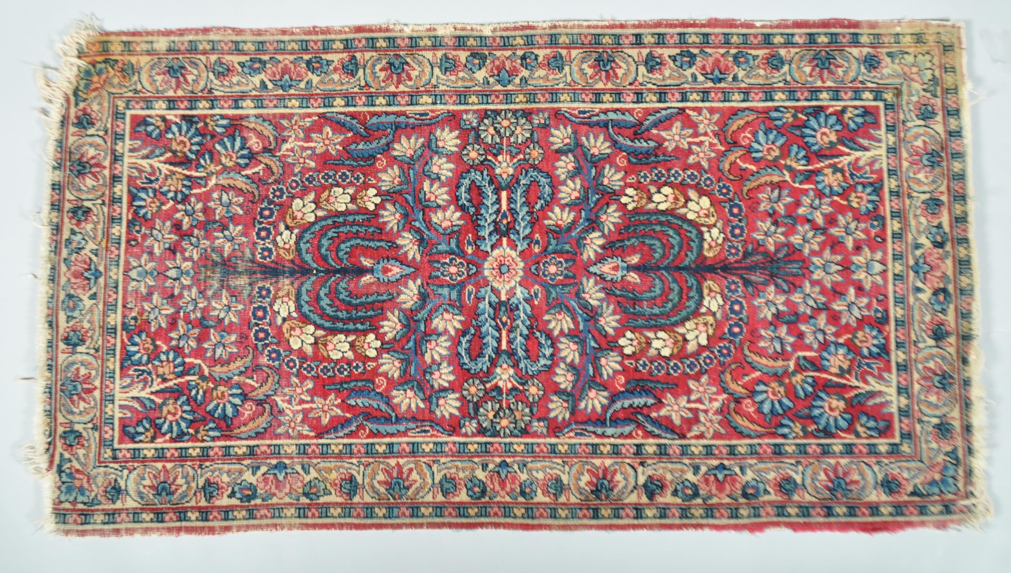 A Middle Eastern small scale carpet claret centre ground,