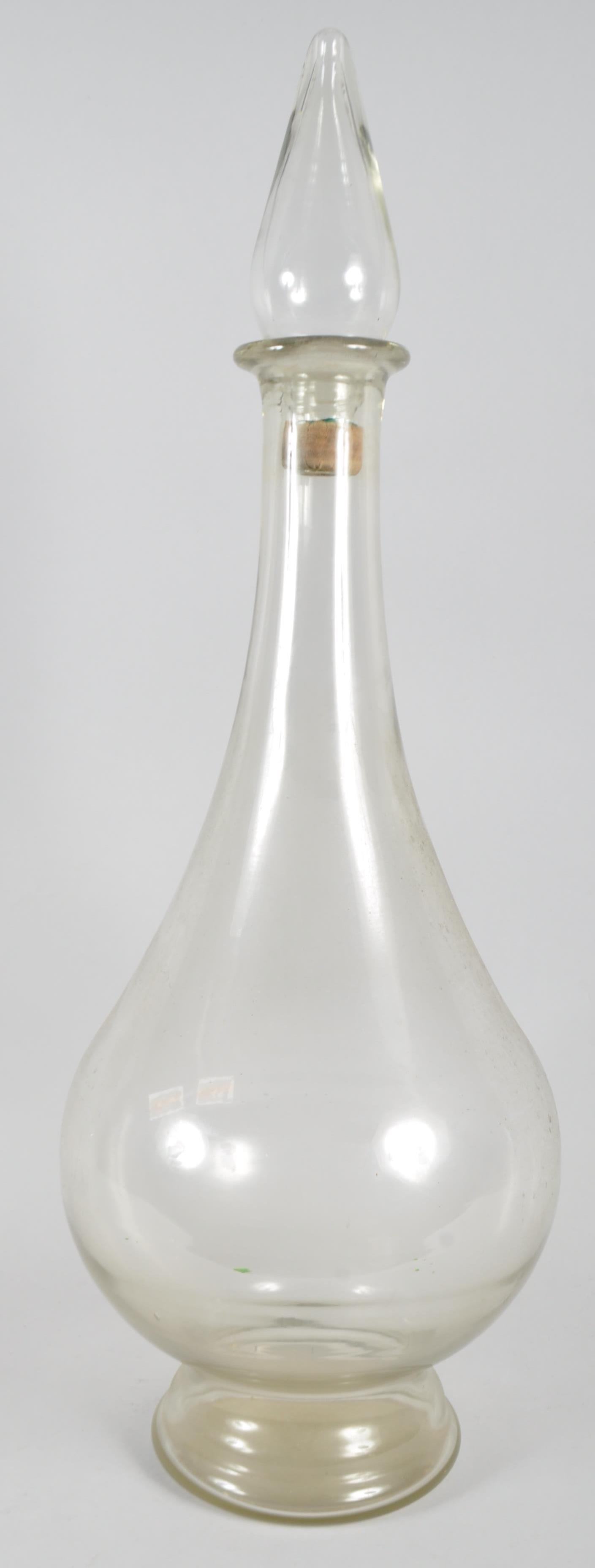 A large glass apothecary bottle an stopper, circa 1900, of baluster form, with spire stopper,