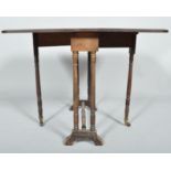 An Edwardian mahogany and inlay Sutherland table having a drop leaf and bevelled edge top