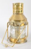 A brass ship's masthead oil lantern, labelled 'Anchor', with swing loop handles to top and base,