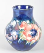 A Moorcroft anemone pattern blue ground oviform vase, with pink and purple flowers,