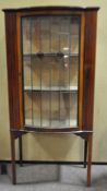 An Edwardian bow front glazed mahogany display cabinet,