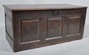 An 18th century oak coffer with three piece triple panelled front and panelled top, 53.