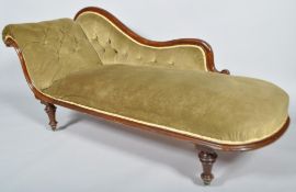 A 19th century mahogany chaise longue having carved strolled decoration,