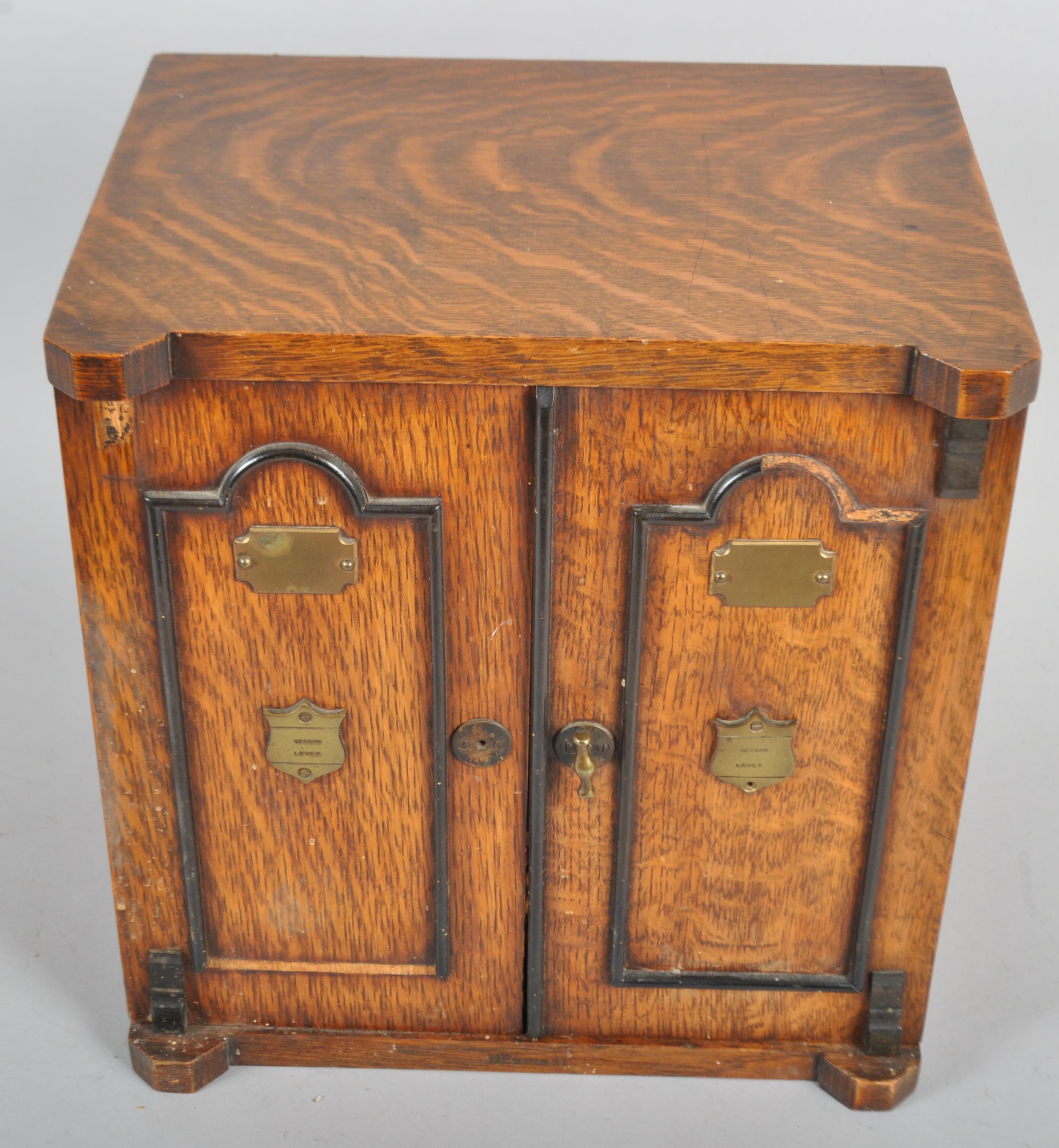 An oak smoker's table-top cabinet, the hinged doors revealing a cupboard, - Image 2 of 2