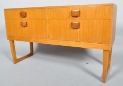 A 1960's retro vintage teak wood four drawer sideboard credenza having with four short drawers