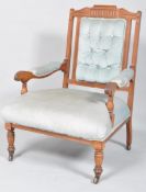 A Victorian armchair, with carved foliate arched top rail and reeded supports, with button back,