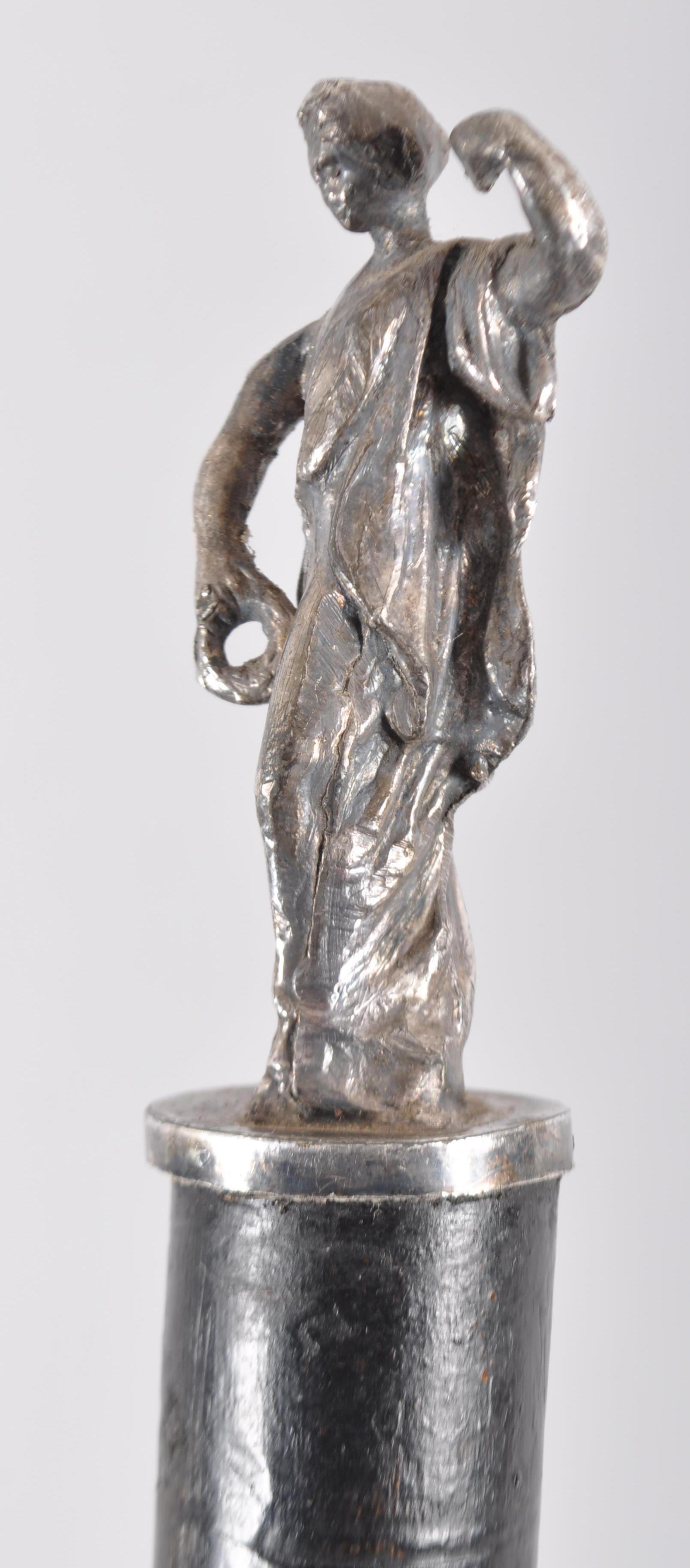 An ebonised walking cane with white metal applied figure of a classical lady, - Image 2 of 2