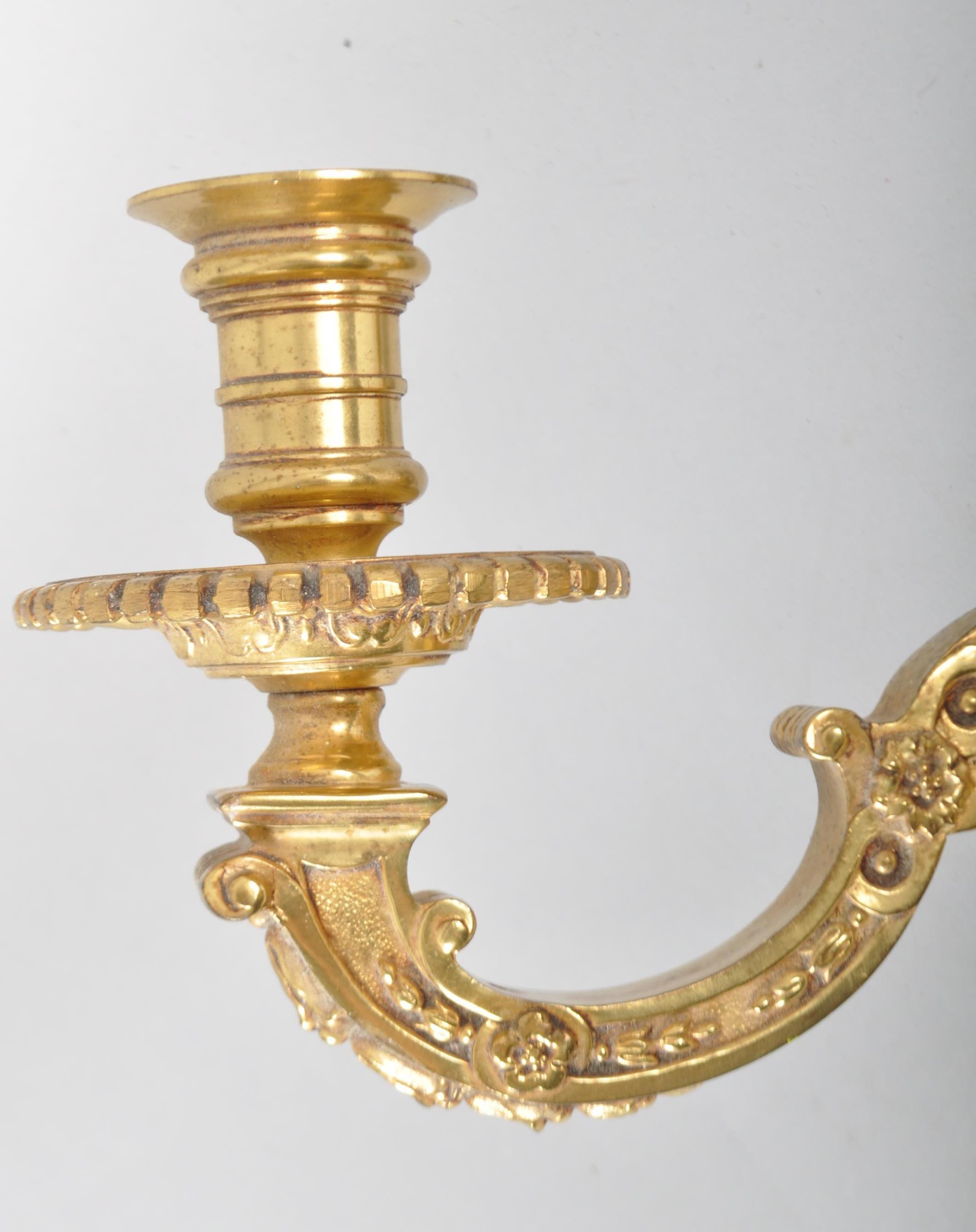 A pair of 20th century brass double wall sconce candlestick electric lights, in the Regence style, - Image 2 of 2