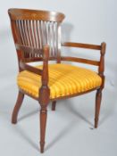 An Edwardian inlaid mahogany open armchair, with trophy inlay to top rail,