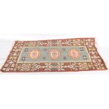 A small possibly Moroccan rug with blue rectangular panel,