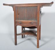 A George III mahogany bedside table, fited tambour drawer and shelf, with later adapted top,