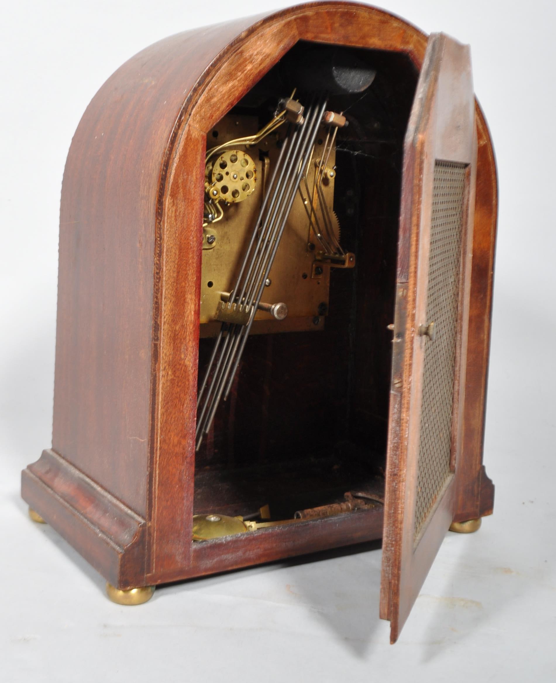 An Edwardian mahogany and inlay arch top mantle clock with carved edge, Roman numeral dial, - Image 2 of 2