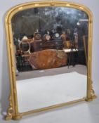 A Victorian gilt wood over mantel mirror, of arched rectangular reeded form,